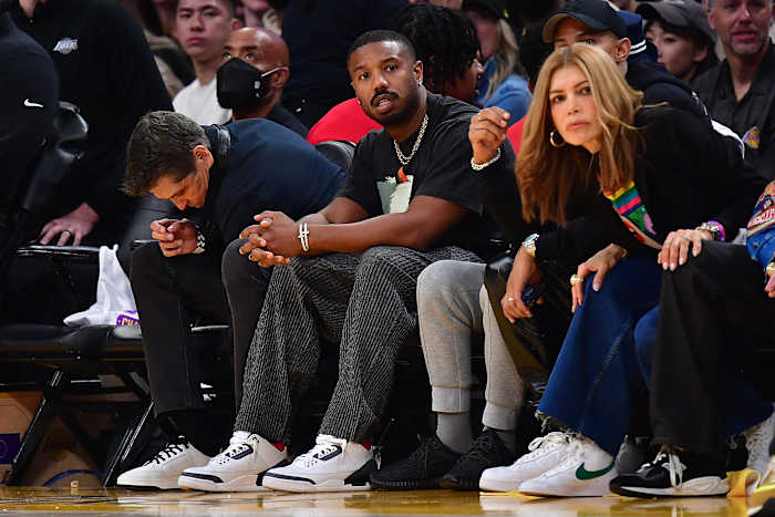Michael B. Jordan sits courtside at an NBA game.